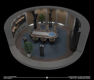 The circular briefing room is in the center of deck one, forward of the main bridge, and has seating for seven people.